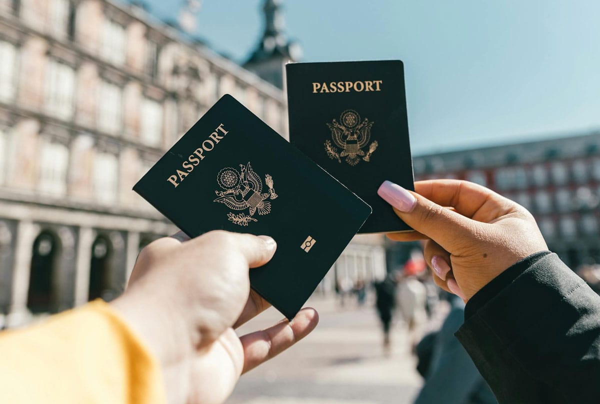 Photo of two people holding their passport